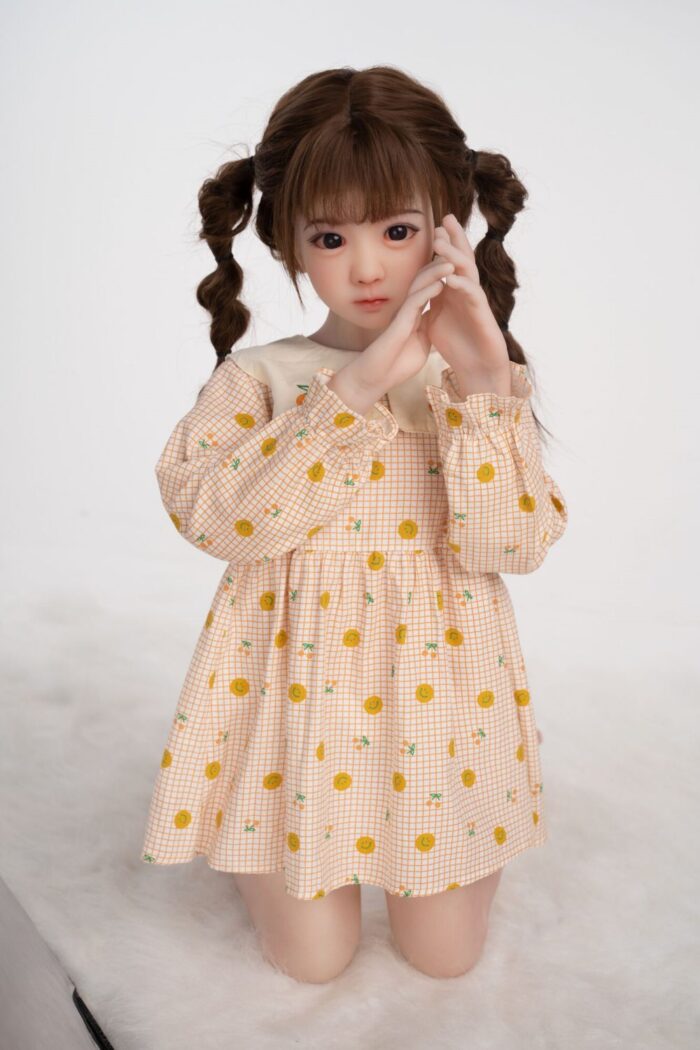 Realistic Japanese Girl Doll With Long Braided Hair And Expressive Eyes, Dressed In A Cute Orange Checkered Dress With Lemon Prints, Perfect For Intimate Companionship Or Collection.