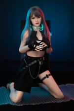 Briana Small Flat Chested Sex Doll with blue hair, black outfit, and futuristic accessories in a dark setting.