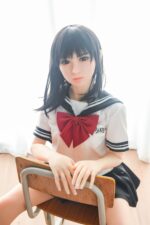 Realistic sex doll girl in schoolgirl uniform with black hair and red bow, lifelike silicone doll with detailed features, perfect for adult pleasure, available at sexdollmini.com.