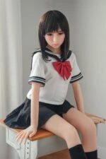 Realistic sex doll girl in school uniform sitting on wooden bench, high-quality silicone love doll for adult entertainment, life-like features, and realistic touch, ideal for companionship and intimacy.