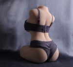 Close-up of a sex doll's torso and hips wearing black lingerie, focusing on realistic skin texture and detailed body features.