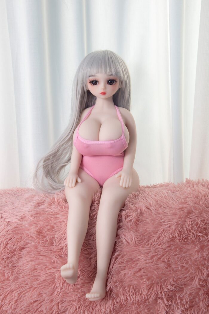 Silicone Sex Doll With Realistic Features And Long Silver Hair Wearing A Pink Swimsuit On A Pink Furry Blanket For Intimate Companionship And Pleasure.