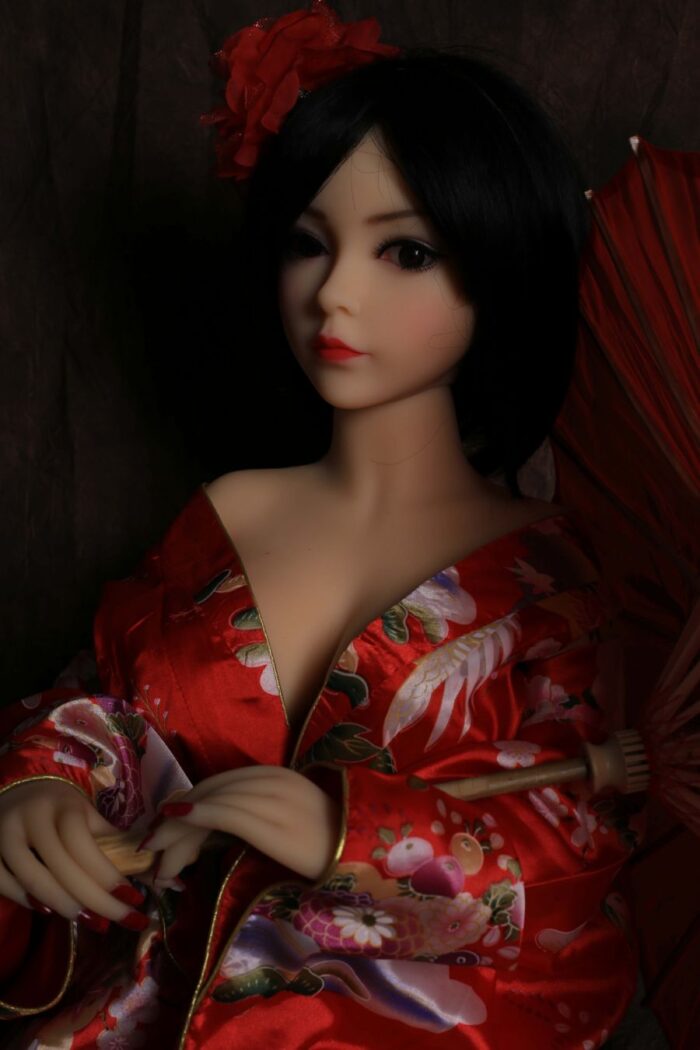 Silicone Sex Doll With Realistic Facial Features, Wearing A Traditional Red Kimono, Lying Down With A Decorative Umbrella, Perfect For Lifelike Companionship And Intimate Experiences.