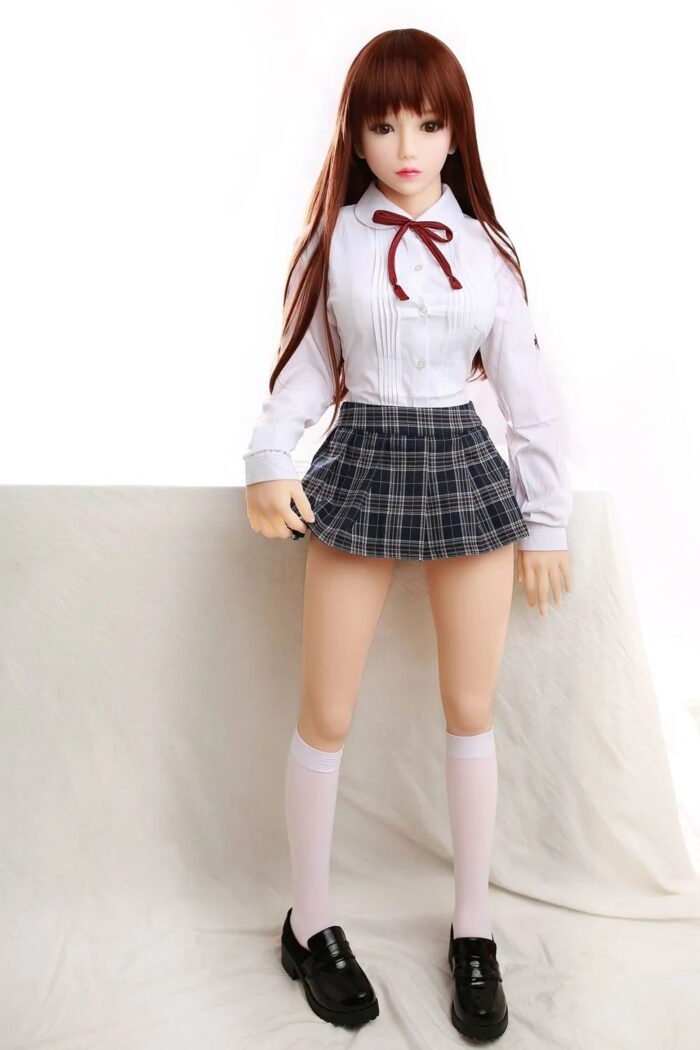 Realistic Sex Doll With Long Auburn Hair, Dressed In Schoolgirl Outfit, For Adult Companionship And Intimate Pleasure. Perfect For Collectors And Those Seeking Lifelike Erotic Dolls.