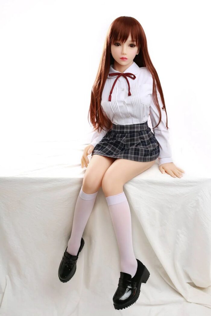 Silicone Sex Doll In Schoolgirl Outfit, Realistic Doll With Detailed Facial Features, Long Auburn Hair, And Poseable Body For Intimate Companionship And Adult Entertainment.