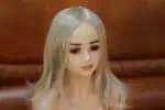 Realistic sex doll with long blonde hair and lifelike features, designed for companionship and intimate experiences, available on Sexdollmini for discreet shopping.