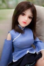 Silicone sex doll with realistic facial features and brown hair wearing a blue traditional dress, designed for companionship and intimate experiences, available at Sexdollmini.