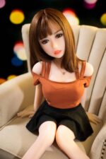 Realistic sex doll with lifelike features, brown hair, and alluring eyes, designed for adult pleasure, available at Sexdollmini for a compact and realistic experience.