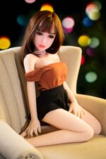 2. Realistic sex doll mini with human-like features, brown hair, and fashionable outfit, perfect for intimacy and companionship.