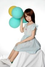 Realistic sex doll with lifelike features and soft silicone skin, dressed in casual clothing, holding colorful balloons for a playful and enticing appearance. Perfect for adult intimacy and companionship.