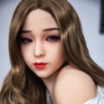 Realistic female doll with long brown hair, blue eyes, and natural makeup, showcasing the Fleur Beautiful TPE Flat Sex Doll.